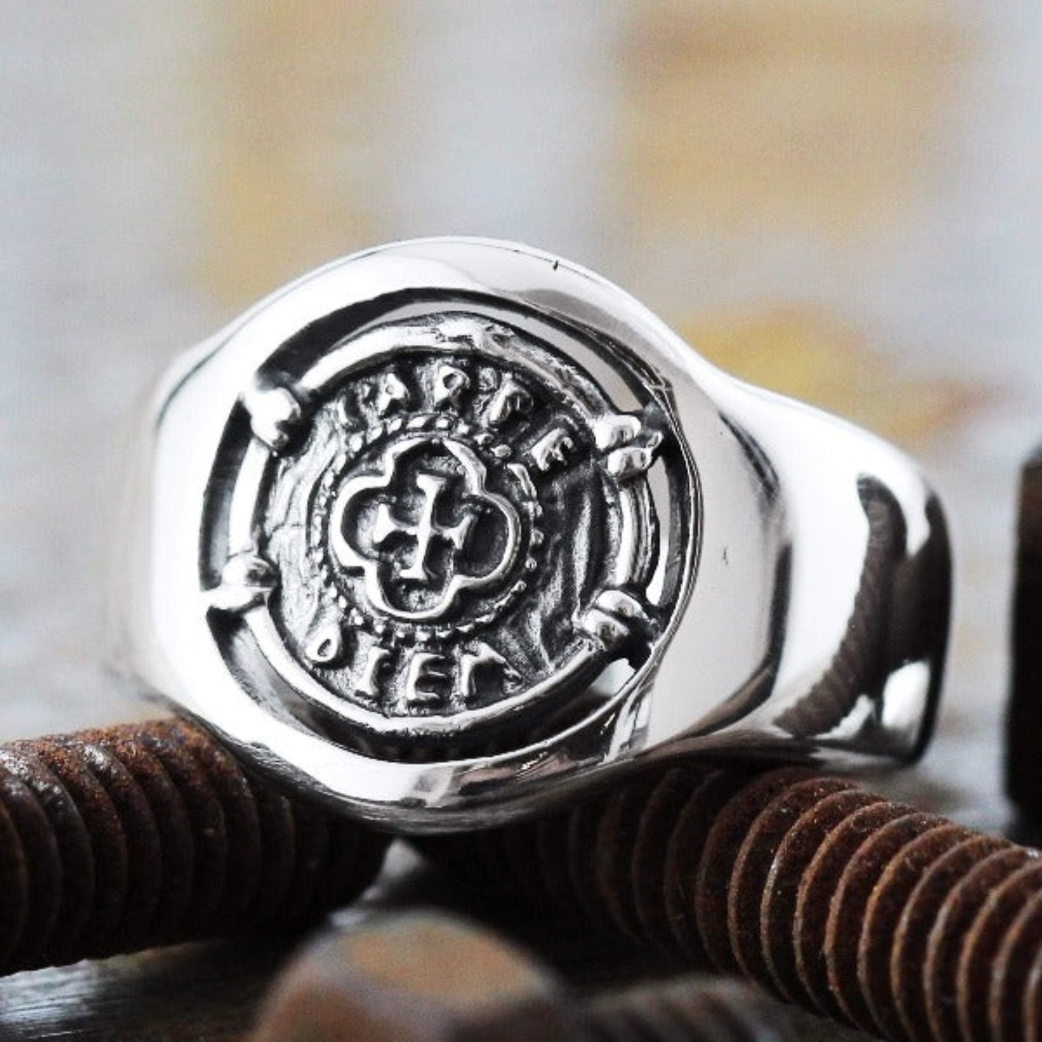 A close-up of a custom engraved ring with the phrase "Carpe Diem."