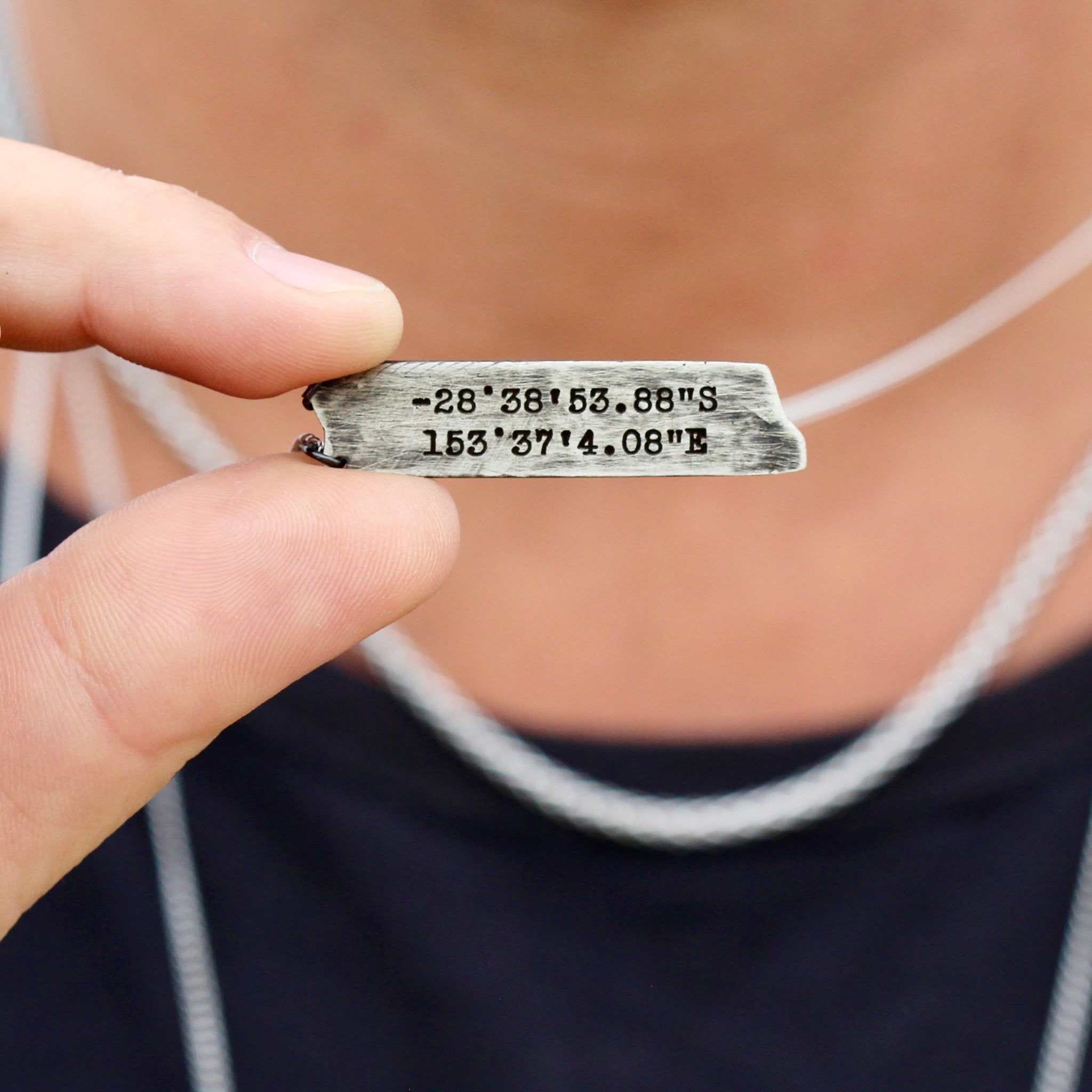 engraved coordinates on silver necklace